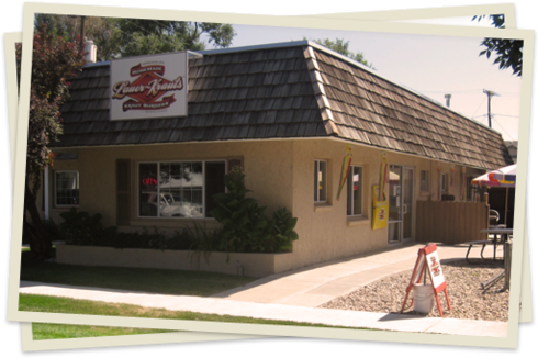 A restaurant with a large building on the corner.